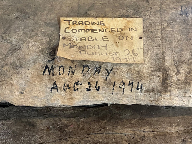 Photograph of texta date and paper sign documenting that 'Trade commenced in Stable on Monday 26th August 1974'